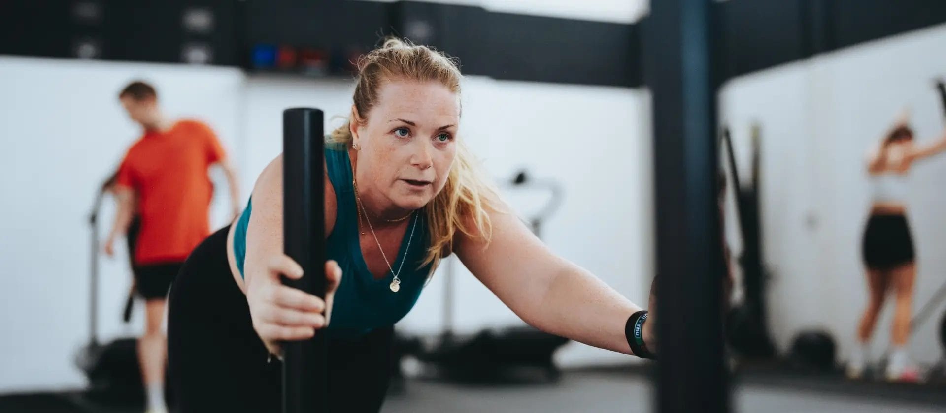 Woman pushing sled indoor